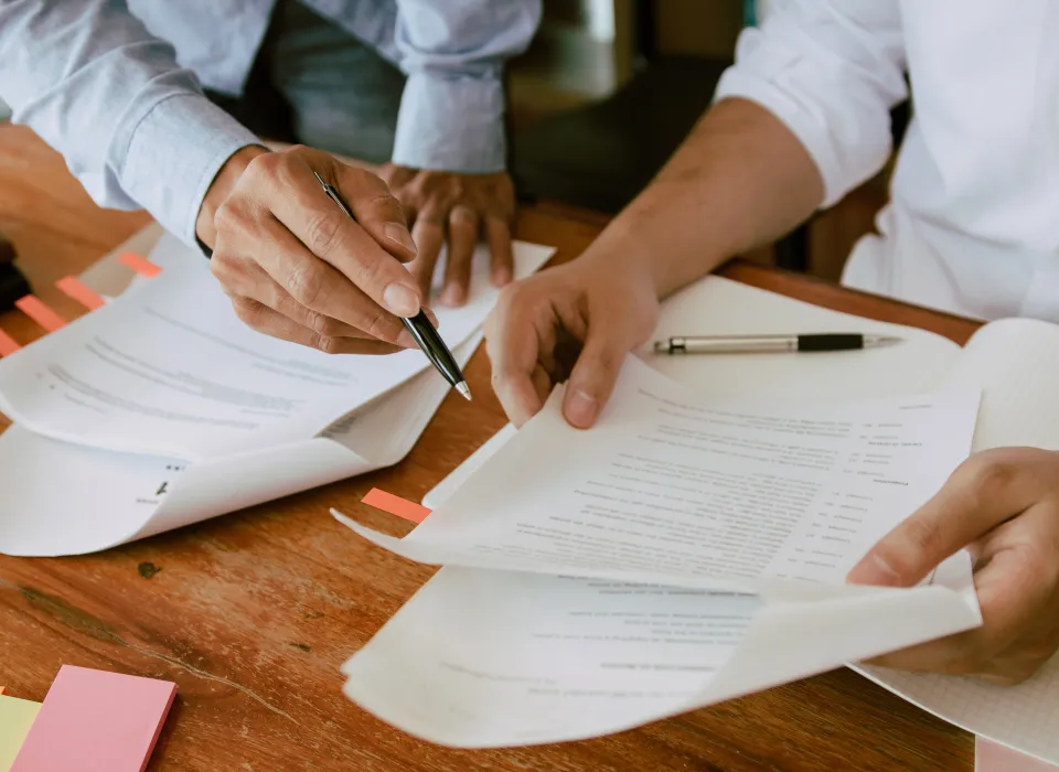 pointing to paper to sign
